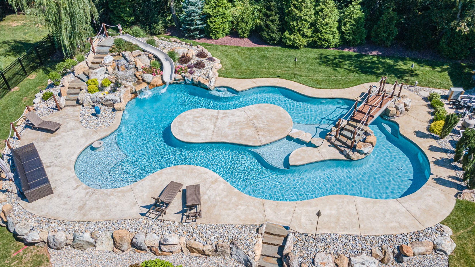 Stellhorn A - Hillsborough, NJ - A large backyard with a swimming pool and a water feature