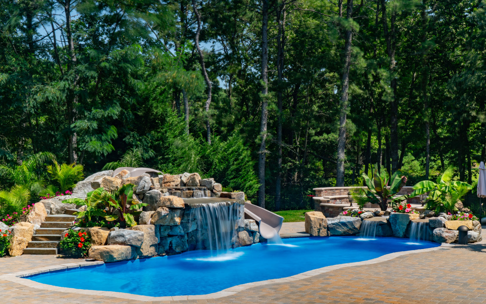 Curatolo A - Galloway, NJ - A swimming pool surrounded by lush greenery and a waterfall feature