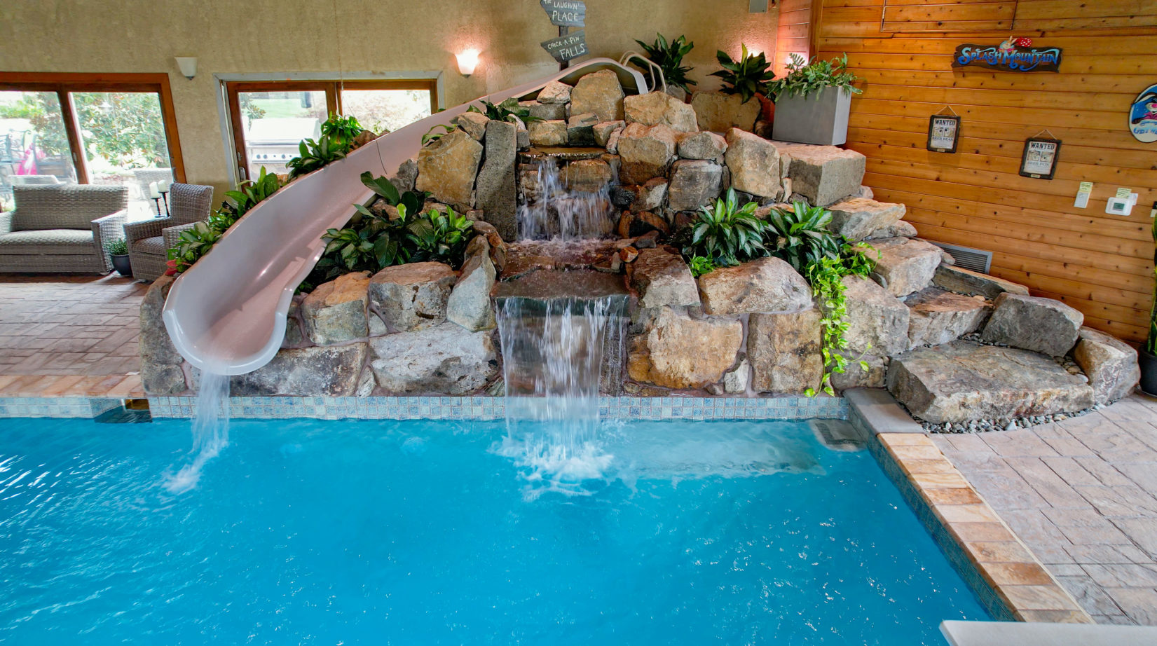 Lucas A - Monroeville, NJ - A large indoor swimming pool with a water feature and a slide