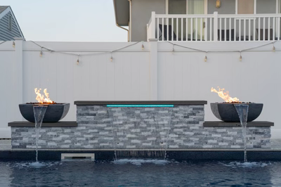 Dune A - Brigantine, NJ - A fire pit sitting on top of a stone wall next to a pool.