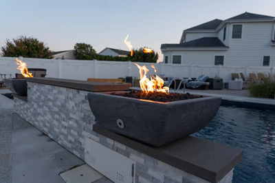 Dune G - Brigantine, NJ - A fire pit sitting next to a swimming pool in a backyard setting