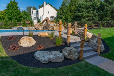 Abiqua G - Doylestown, PA - A backyard with a play area and a large house in the background