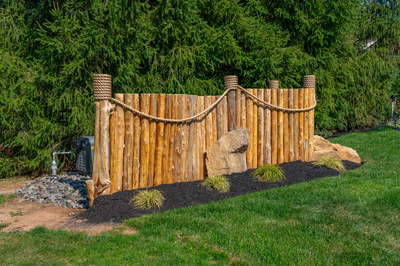Abiqua K - Doylestown, PA - A wooden fence with rope and rocks in a garden setting