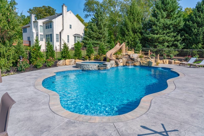 Abiqua N - Doylestown, PA - A large white house with a pool and a water slide in a backyard setting