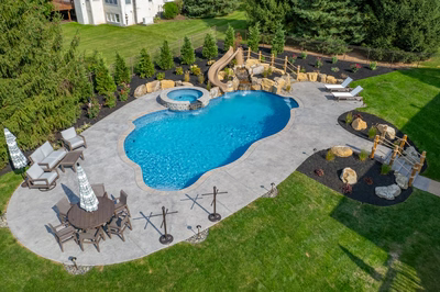 Abiqua P - Doylestown, PA - A backyard with a swimming pool, patio, and play area