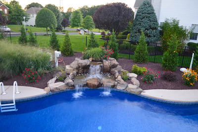 Alger F - Monroe, NJ - A backyard with a swimming pool and a waterfall feature