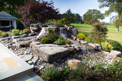 Alpine B - Moorestown, NJ - A large rock garden with a waterfall in the middle of it