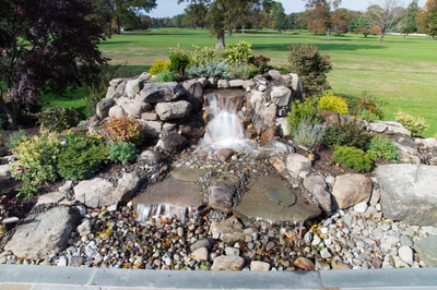 Alpine E - Moorestown, NJ - A rock garden with a waterfall in the middle of it