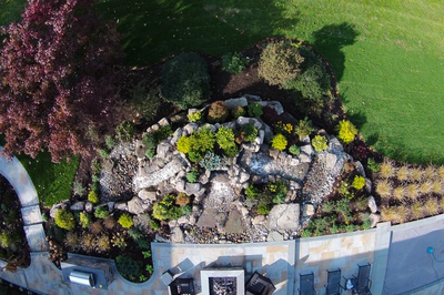 Alpine G - Moorestown, NJ - A bird's eye view of a well-maintained garden with a fire pit and seating area