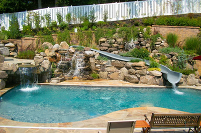 Angel B - Voorhees, NJ - A swimming pool with a waterfall and a slide in a backyard setting