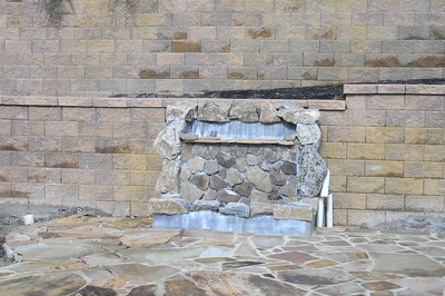 Angel E - Voorhees, NJ - A stone wall with a water feature in the middle of it