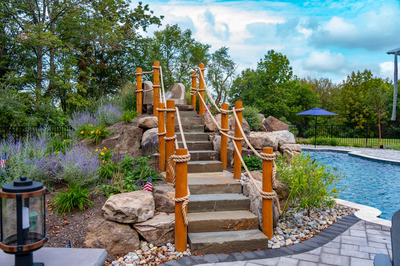 Antelope E - Ringoes, NJ - A rock climbing wall with rope structures next to a swimming pool.