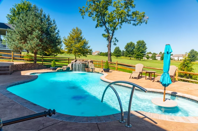 Apsley F - Gilbertsville, PA - A large backyard with a swimming pool and a waterfall.
