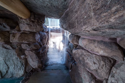 Armstrong H - Moorestown, NJ - A small waterfall cascades through a rocky passage, with sunlight filtering through the rocks