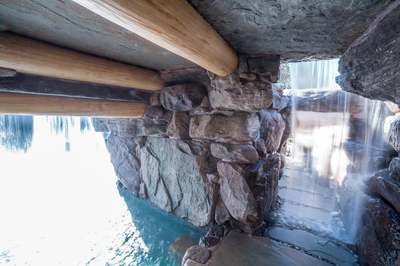 Armstrong I - Moorestown, NJ - A view of a waterfall through a stone structure with wooden beams