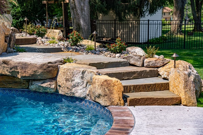 Augrabies G - West Deptford, NJ - A backyard with a swimming pool surrounded by rocks and plants