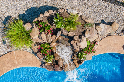 Azure E - Hillsborough, NJ - A bird's eye view of a swimming pool surrounded by rocks and flowers