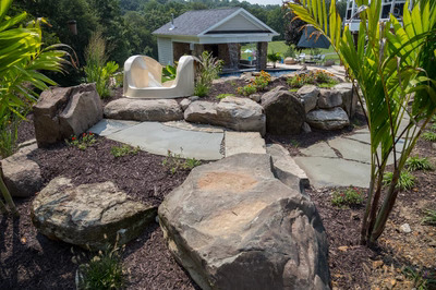 Barron D - Fallston, MD - A stone walkway leads to a small house surrounded by lush greenery and flowers
