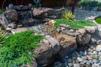 Basin J - Wenonah, NJ - A rock garden with a small waterfall in the middle