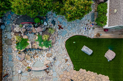 Basin M - Wenonah, NJ - A bird's eye view of a backyard with a rock garden and artificial grass
