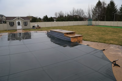 Beach C - Lumberton, NJ - A backyard with a pool and a fence covered in a tarp
