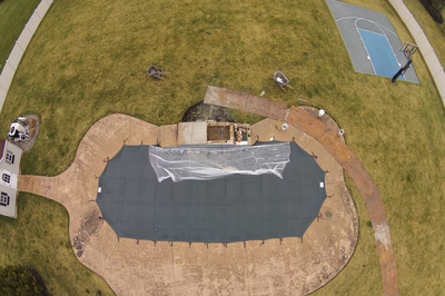 Beach E - Lumberton, NJ - A large rectangular pool surrounded by a grassy area with a basketball court in the background