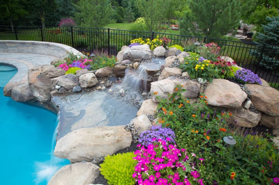 Bearcamp C - Mechanicsburg, PA - A rock garden with colorful flowers next to a swimming pool