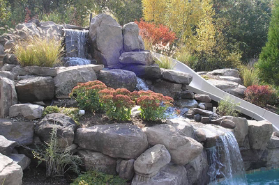 Beecher F - Wall, NJ - A rock garden with a water feature and a slide