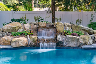 Belding B - Queenstown, MD - A swimming pool with a waterfall surrounded by rocks and plants