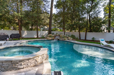 Belding H - Queenstown, MD - A backyard with a swimming pool surrounded by trees and a white fence