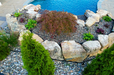 Belmore F - Highland, MD - A rock garden with a swimming pool in the background