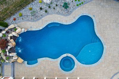 Belmore G - Highland, MD - A bird's eye view of a swimming pool surrounded by landscaping and rocks