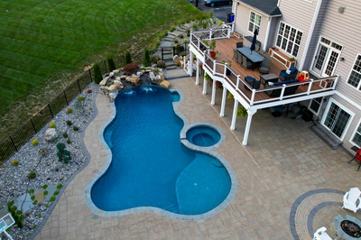 Belmore I - Highland, MD - A large backyard with a swimming pool and patio area.