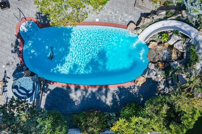 Benham U - Cape May Courthouse, NJ - A bird's eye view of a swimming pool surrounded by greenery and rocks
