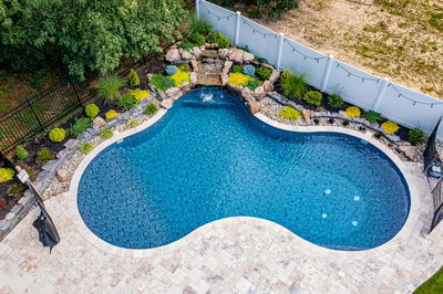 Benton K - Egg Harbor, NJ - A backyard with a swimming pool surrounded by landscaping and a fence