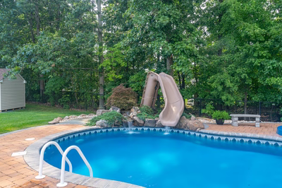 Blackwater D - Monroe, NJ - A swimming pool with a water feature and a slide in a backyard setting