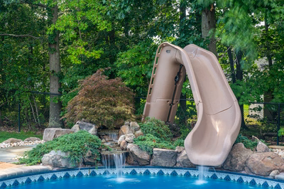 Blackwater E - Monroe, NJ - A water slide in the middle of a swimming pool surrounded by lush greenery