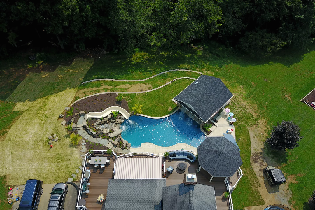 Bocek H - Fallston, MD - A bird's eye view of a backyard with a swimming pool surrounded by lush greenery
