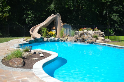 Bristol A - Hamilton, NJ - A swimming pool with a water feature and a slide in a backyard setting