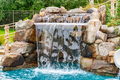 Bruar F - Millstone, NJ - A small waterfall cascades over rocks into a turquoise pool surrounded by lush greenery