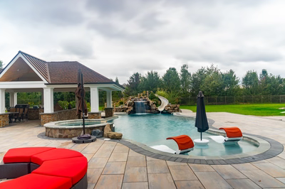 Bruar J - Millstone, NJ - A backyard with a pool and a gazebo surrounded by lush green grass and trees