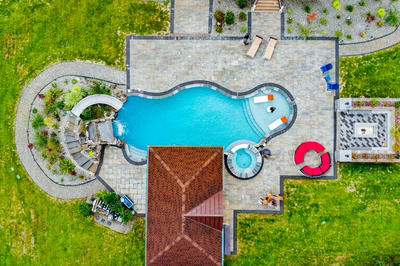 Bruar N - Millstone, NJ - A bird's eye view of a backyard with a swimming pool surrounded by lush green grass