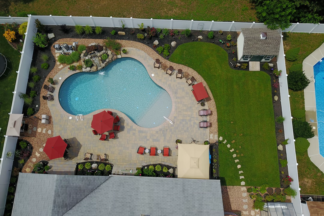 Brunner E - Bayville, NJ - A bird's eye view of a backyard with a swimming pool surrounded by landscaping