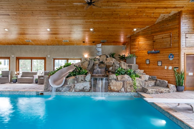 Bumpass B - Monroeville, NJ - A large indoor swimming pool with a water feature and a slide
