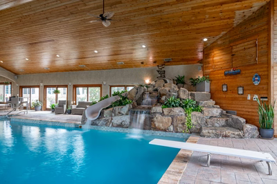 Bumpass C - Monroeville, NJ - A large indoor swimming pool with a waterfall and a water feature