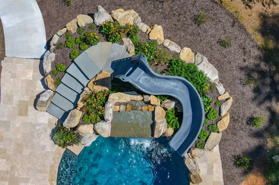 Burney - Matawan, NJ - A bird's eye view of a swimming pool with a water feature and a water slide