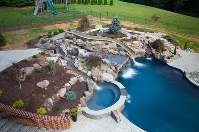 Bushkill D - Churchville, MD - A backyard with a swimming pool, waterfall, and play area