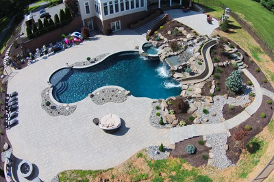 Bushkill E - Churchville, MD - A large backyard with a swimming pool and a waterfall.