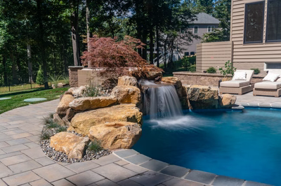 Castor G - Fallston, MD - A backyard with a swimming pool and a waterfall feature
