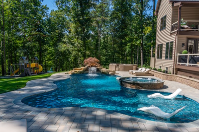 Castor J - Fallston, MD - A backyard with a swimming pool and a play area surrounded by trees